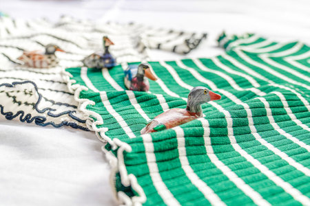 Wooden Craft Ducks are swimming on the green wave cloth concept design.