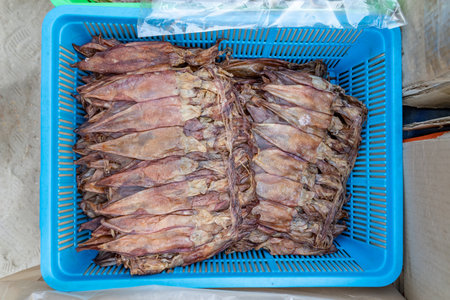 a lot of brown squids that have been placed in a plastic bag to dry in the sun. It is not uncommon...