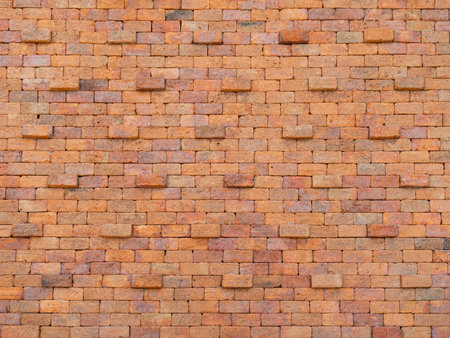 The ancient red brick wall stood tall and imposing, its intricate details and wear adding to its...