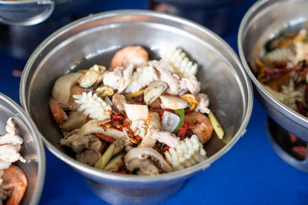 With its spicy and tangy flavors, Tom Yum is the perfect dinner choice, and I've assembled all the necessary seafood ingredients in the pot to make it.の写真素材