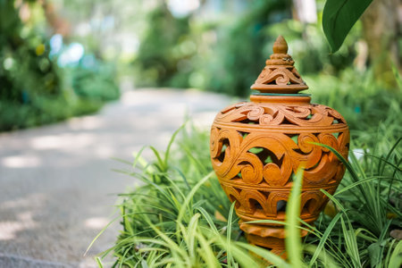 The close up photo of the outdoor handmade carving ceramic clay lamp in the exquisite Thai style...