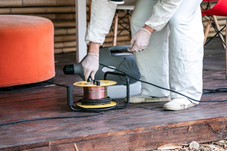 Professional technical man in prevention suit with his sterilizing machine and disinfecting water...