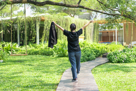 Portrait of the Asian glassese Thai woman is standing in the garden in the morning.