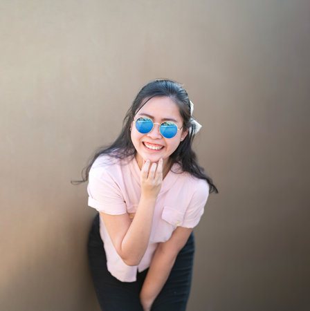 Asian glasses long hair girl is silhouette posting for camera shooting on the rooftop, top of...