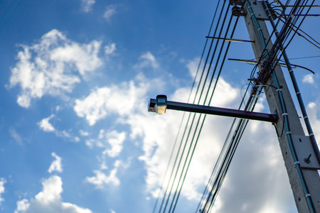 cctv camera is installed on the Metal stick that hung on to electric pole beside the street in...