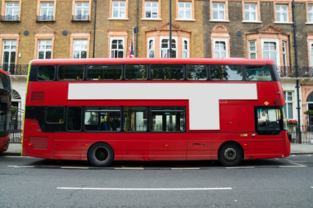 The blank ad space on the red bus contrasts with the classic charm of the calm London street.