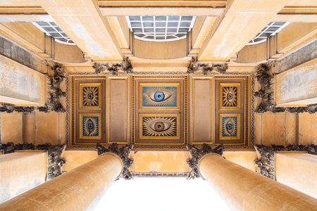 The grand entrance of Blenheim Palace, with its monumental columns and ornate ceiling adorned with...