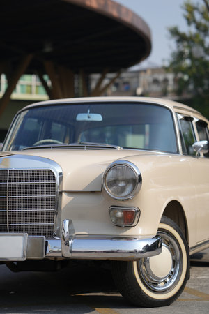 The chrome bumper of a vintage car glows with light, adding to the car classic allure and sleek...
