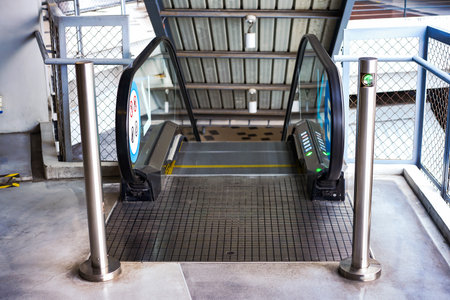 LED green light arrow Signage stainless pole in front of escalator sign the passenger the right way up and down.の写真素材