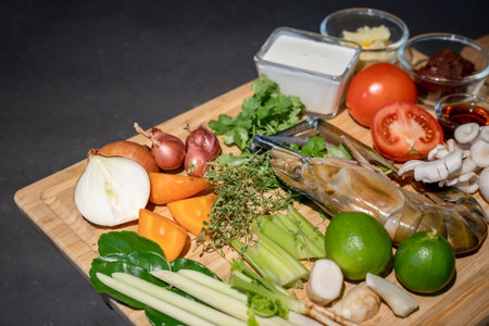 Close up the Ingredients set of TomYamKung (Shrimp Spicy Thai Soup) is a prawn, lemon condiment sauces and the others on the kitchen counter.の写真素材