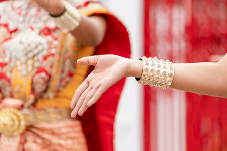 Close up hand of Thai folk dance during celebration on temple background. Thai traditional dance on event celebration.の写真素材