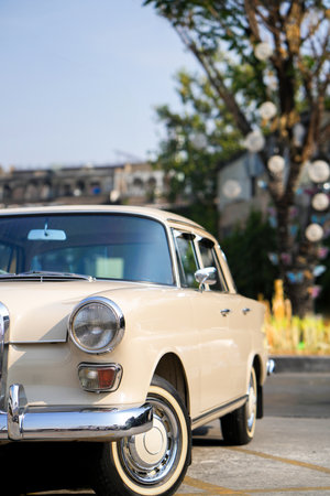 The round headlights and side turn signals on classic cars, framed in polished chrome, highlight the vintage style with old-fashioned lighting and curved fender details.の写真素材