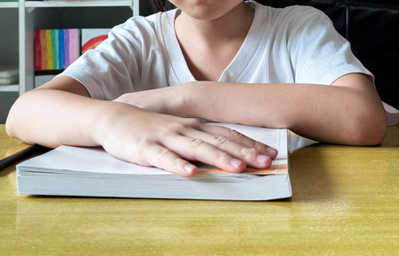 A student engages in independent learning, carefully completing workbook tasks without any assistance.の写真素材