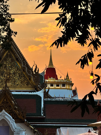 The Golden Mount Temple shines under a warm sunset sky in Bangkok reflecting peace faith and beauty...