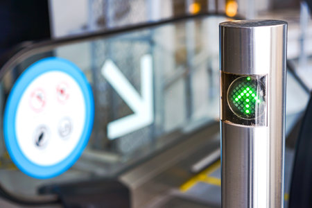 LED green light arrow Signage stainless pole in front of escalator sign the passenger the right way up and down.の写真素材