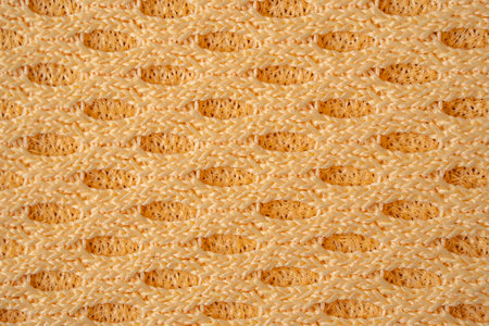 Breathable yellow design showcases the innovation of airflow and comfort in engineered fabric,...