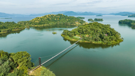 Kaeng Krachan dam with lake view and many green mountains, blue sky background. Kaeng Krachan Dam national park, Phetchaburi province, Thailand in aerial view from drone.の写真素材