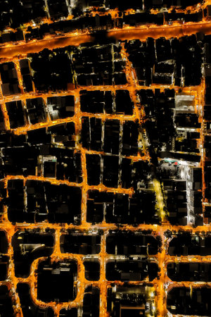 Night shot topview reveals the endless maze of houses and housing that make up the bustling city,...