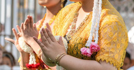 Traditional Thai dance close perspective focusing on expressive hand and foot gestures with...
