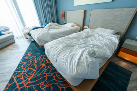 Interior of a hotel room with double bed and pillows.