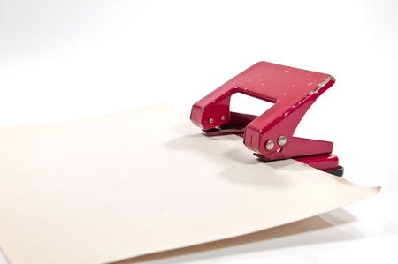 old hole punch with old paper on white backgroundの写真素材