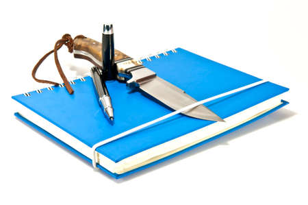 pen and knife on notebookの写真素材
