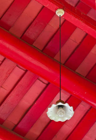Lamp hung up  on wooden backgroundの写真素材