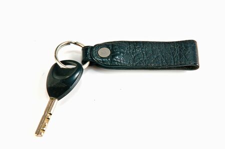 old key attached to a leather keychainの写真素材