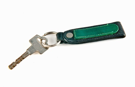old key attached to a leather keychain