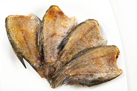 fried trichogaster pectoralis fish on white dish