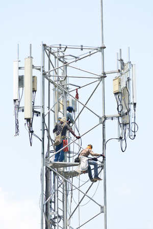 Technician working on communication towersの写真素材