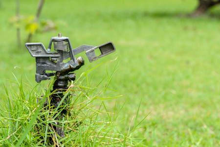 metal automatic water sprinkler in the gardenの写真素材