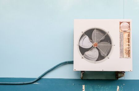 old Air Compressor on wallの写真素材