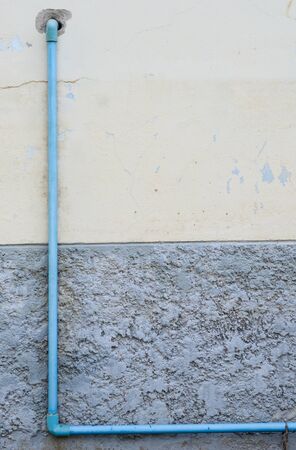 background of pvc pipe on old cement wallの写真素材