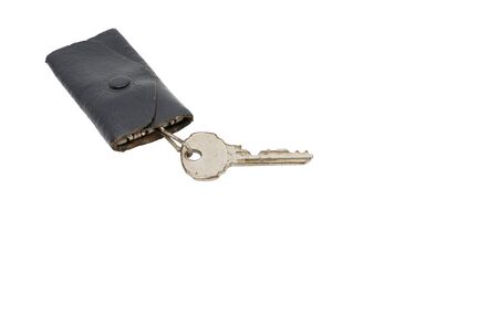 keys and leather storage case that has usage traces on a white backgroundの写真素材