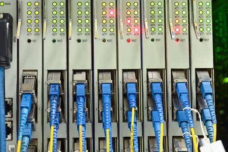 optical distribution  panel and fiber cables with connector closeup in  data centerの写真素材