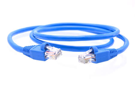 blue LAN cable that is coiled in a circle on white background closeupの写真素材