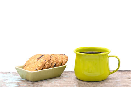 black coffee in green metal cup  and oat crackers on  white backgroundの写真素材