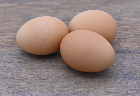 three eggs on wood close upの写真素材