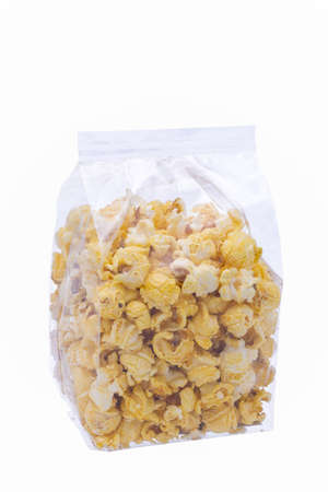 buttered popcorn in plastic bag fir sale on white backgroundの写真素材