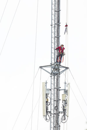 engineer work on communication tower