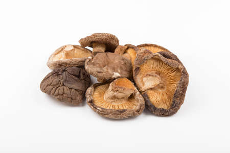 dry shitake mushroom pile on white background