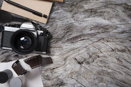 camera and supplies, Blank photo  on wood table. Top viewの写真素材