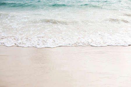 Wave of the sea on the sand beach for backgroundの写真素材