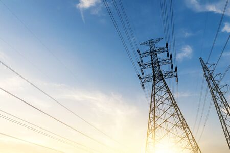 The silhouette of the evening electricity transmission pylon