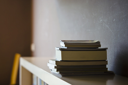 Book stack on a shelf with shade lighting