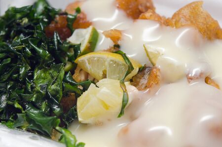 Fried chicken with lemon sauce served with herb (famous thai food)