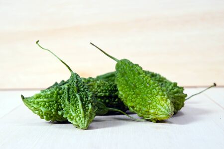 Closeup view of bitter gourd over wooden board backgroundの写真素材