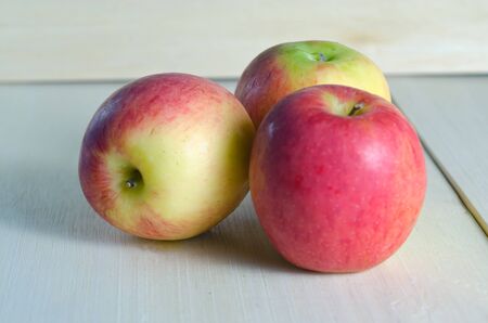 Apple close-view isolated on wooden board background