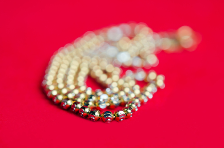 Gold necklace 96.5 precent Thai gold design with gold heart pendant isolated on red flannel cloth の写真素材